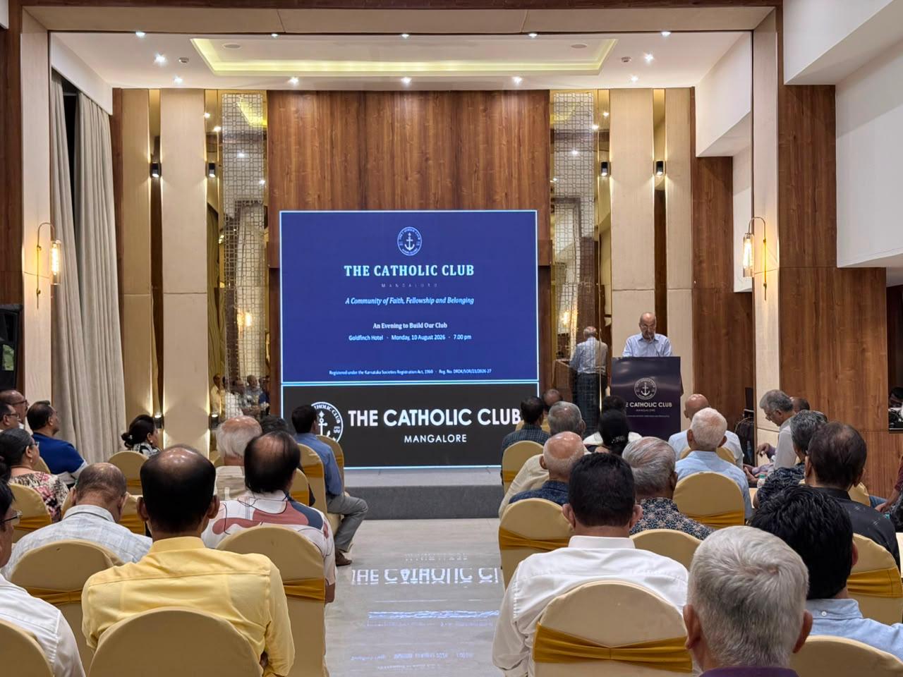 An informational meeting and presentation for The Catholic Club Mangalore held before an audience at the Goldfinch Hotel.
